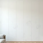 Dalle PVC murale blanche installée dans un salon de location meublé avec mobilier minimaliste